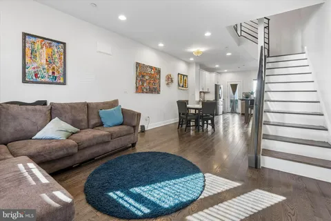 a living room with furniture and wooden floor