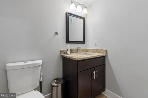 a bathroom with a sink toilet and mirror