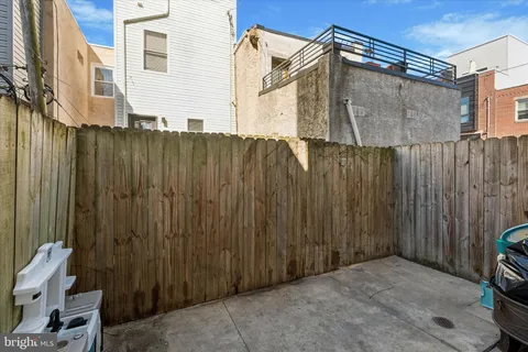 a view of a house with a wooden fence