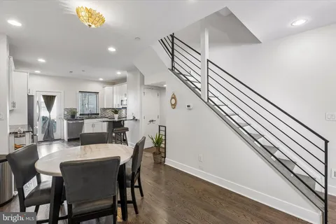 a dining room with furniture and entryway