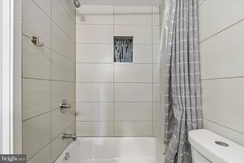 a bathroom with a shower and a toilet