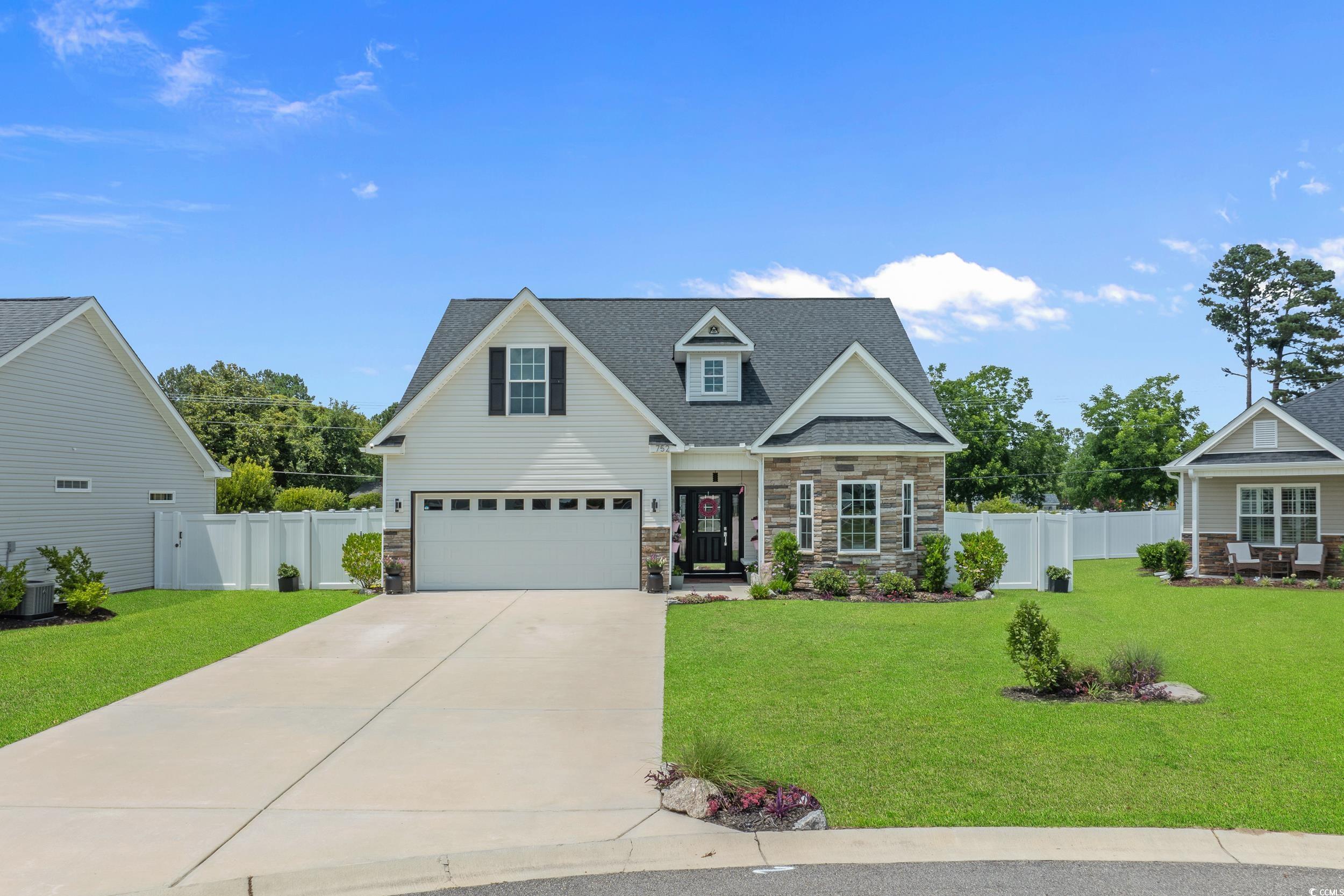 752 Hobonny Loop Longs, SC 29568 - Photo 1 of 40 View of front of house featuring stone siding, concrete driveway, an attached garage, and a shingled roof