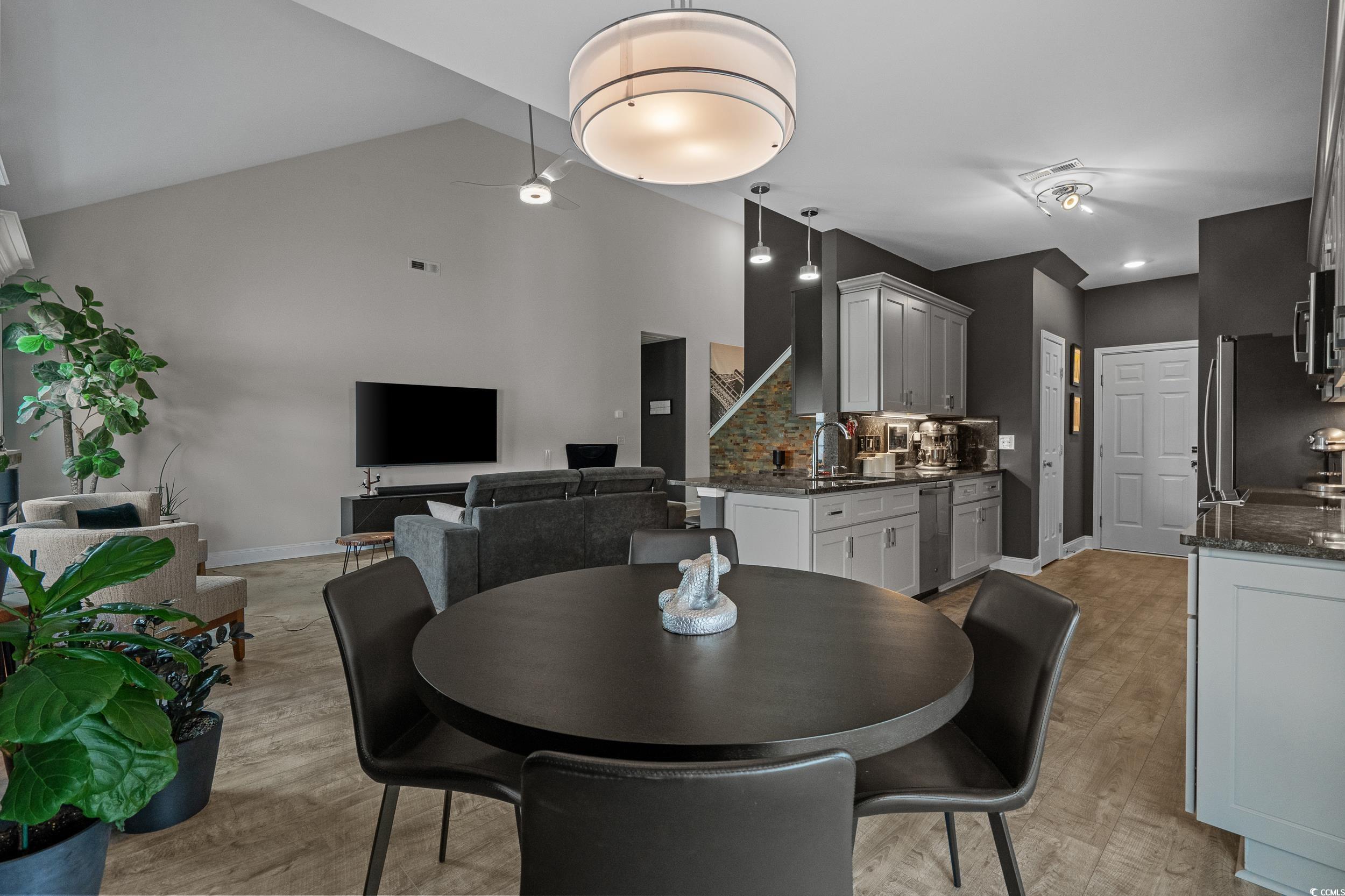 752 Hobonny Loop Longs, SC 29568 - Photo 12 of 40 Dining space with light wood-type flooring, high vaulted ceiling, and stairs