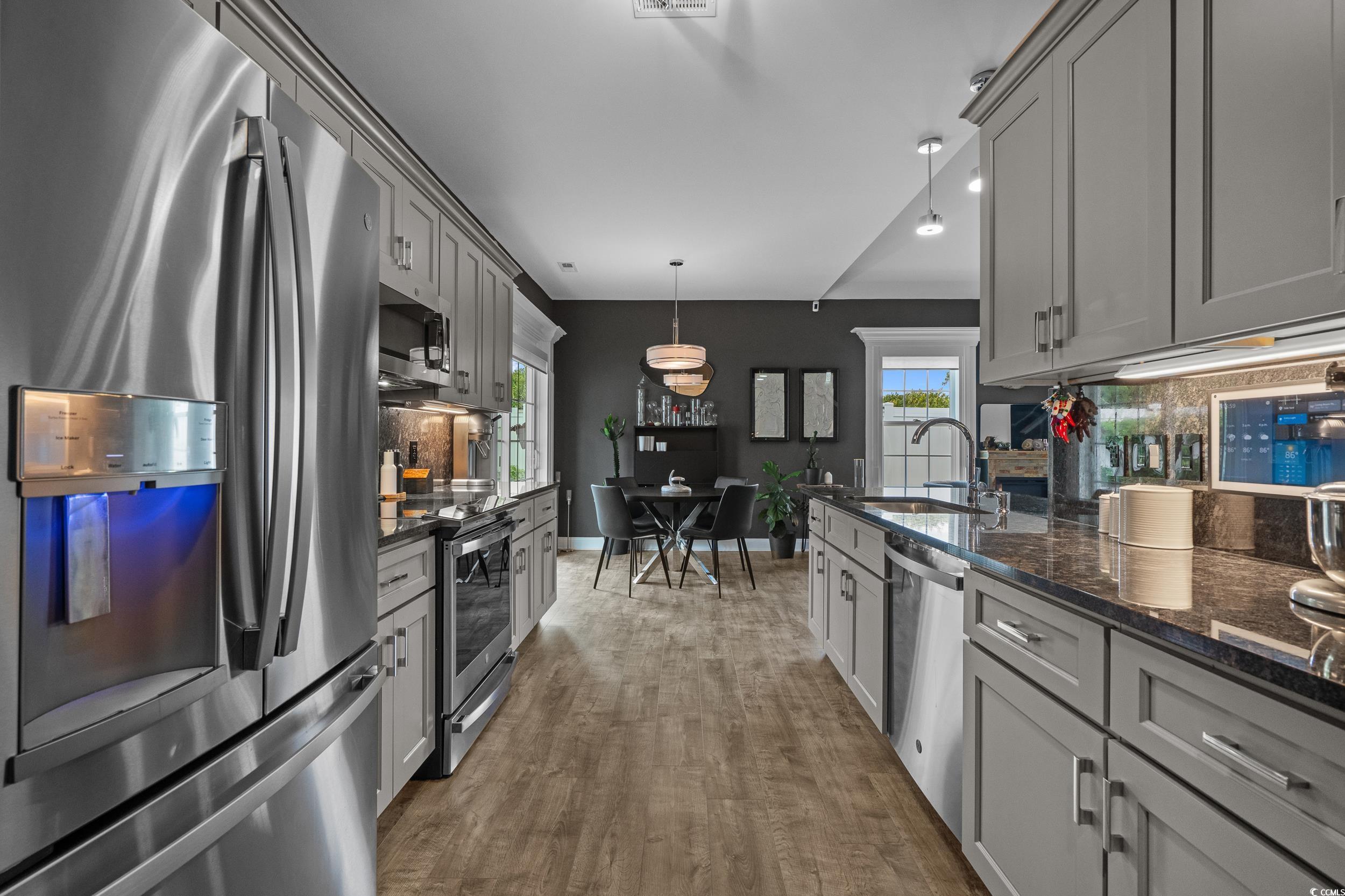 752 Hobonny Loop Longs, SC 29568 - Photo 16 of 40 Kitchen with stainless steel appliances, gray cabinets, backsplash, and dark wood-style flooring