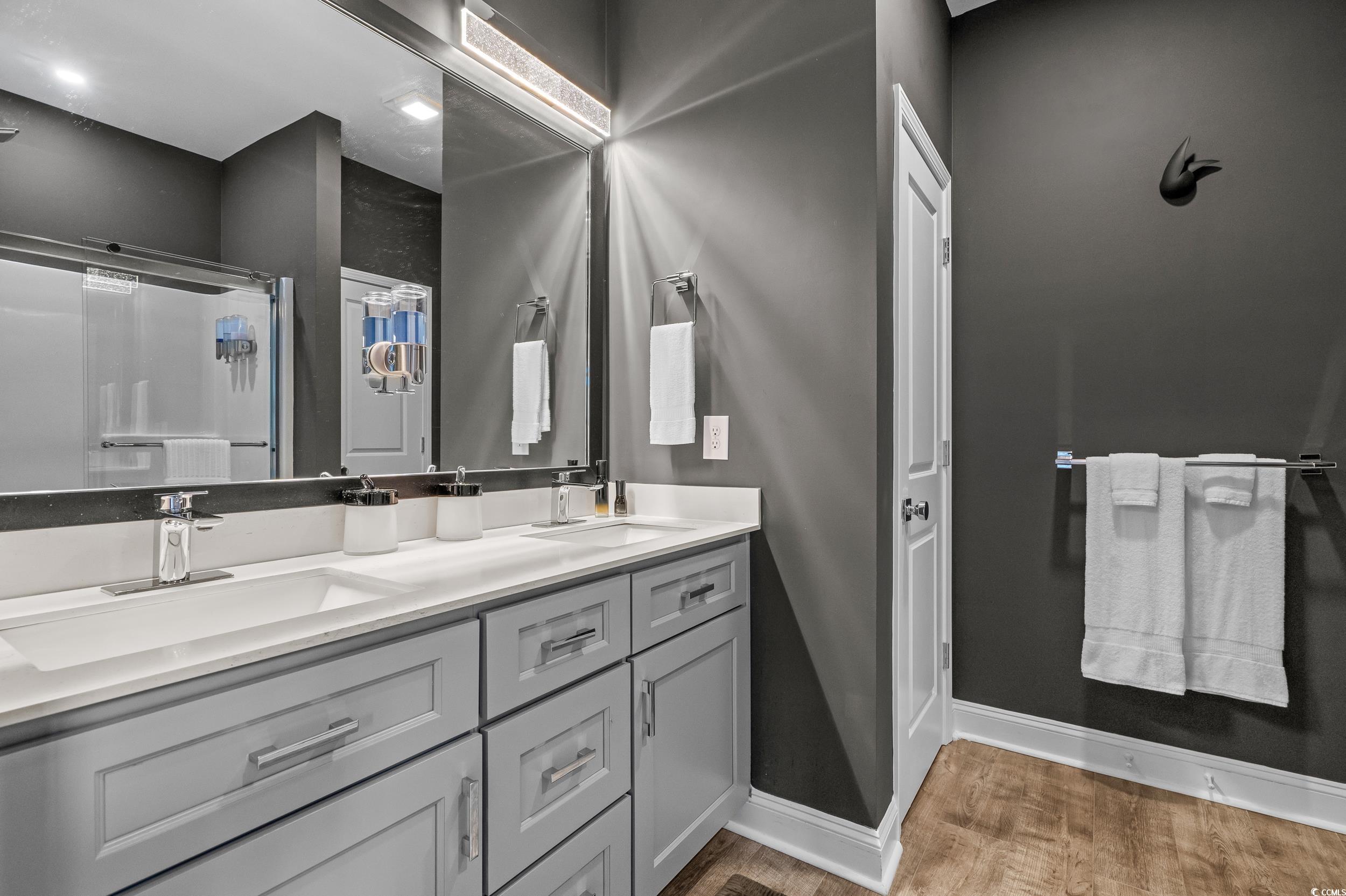 752 Hobonny Loop Longs, SC 29568 - Photo 19 of 40 Bathroom with wood finished floors, double vanity, and a shower