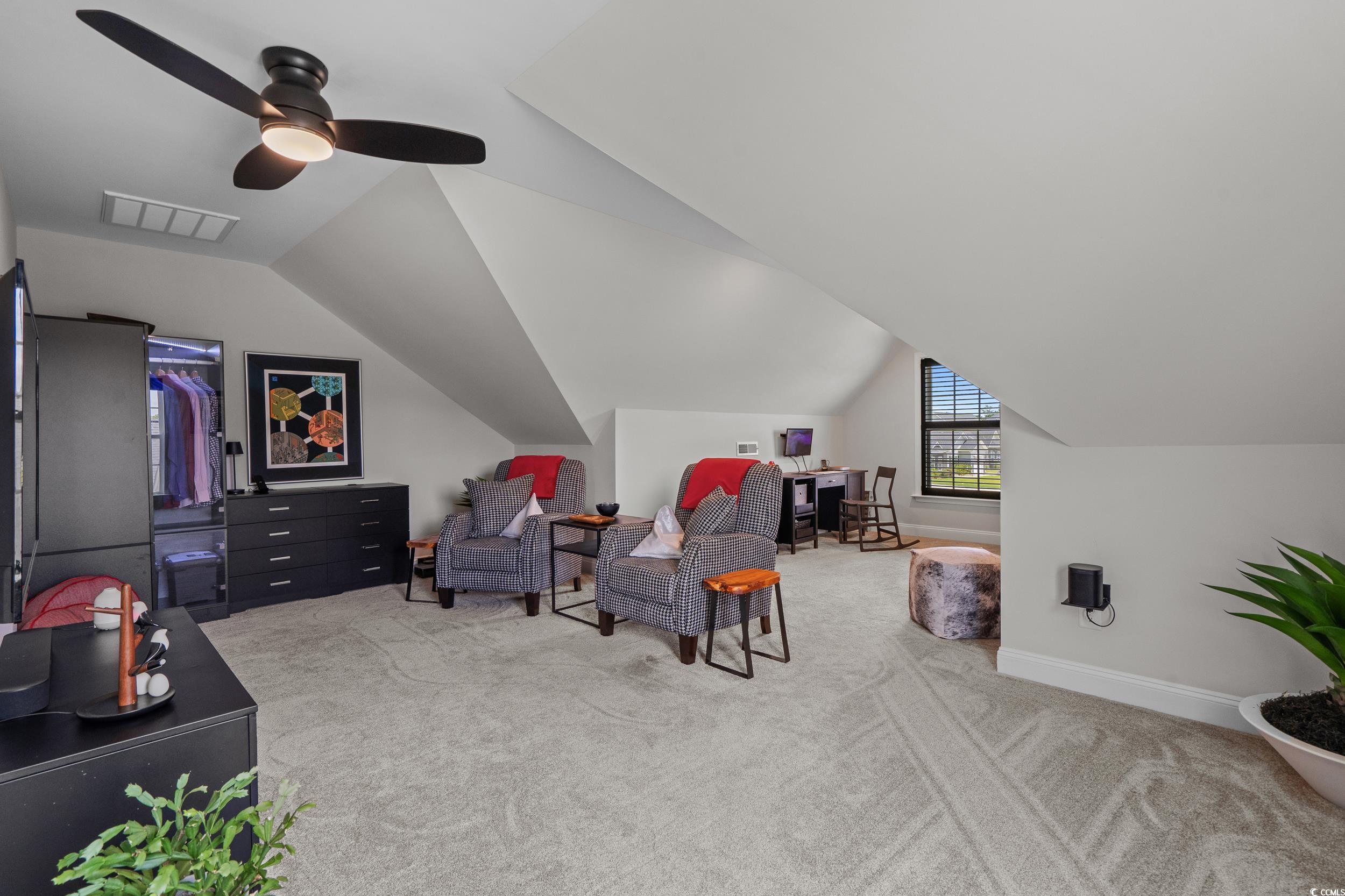 752 Hobonny Loop Longs, SC 29568 - Photo 25 of 40 Living area featuring carpet floors, vaulted ceiling, and a ceiling fan