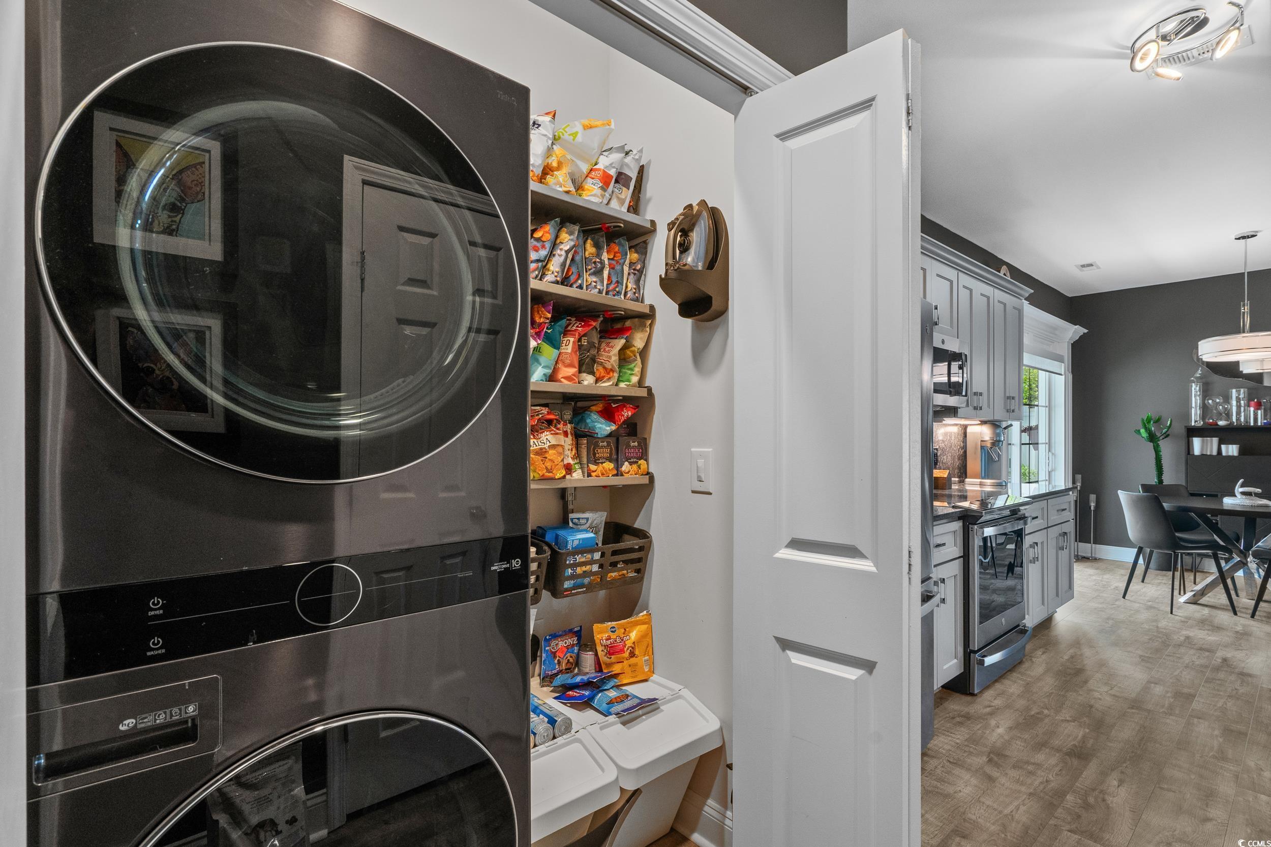 752 Hobonny Loop Longs, SC 29568 - Photo 30 of 40 Laundry room with stacked washer / dryer and light wood-style flooring