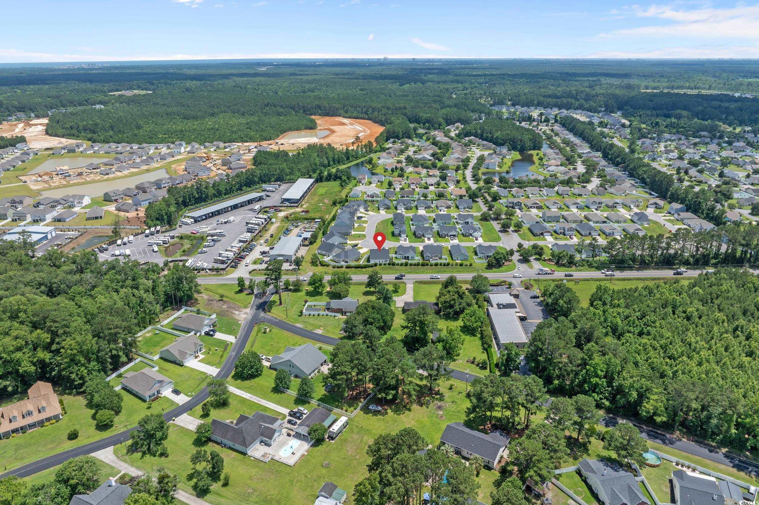 752 Hobonny Loop Longs, SC 29568 - Photo 39 of 40 Aerial view of property and surrounding area with a heavily wooded area