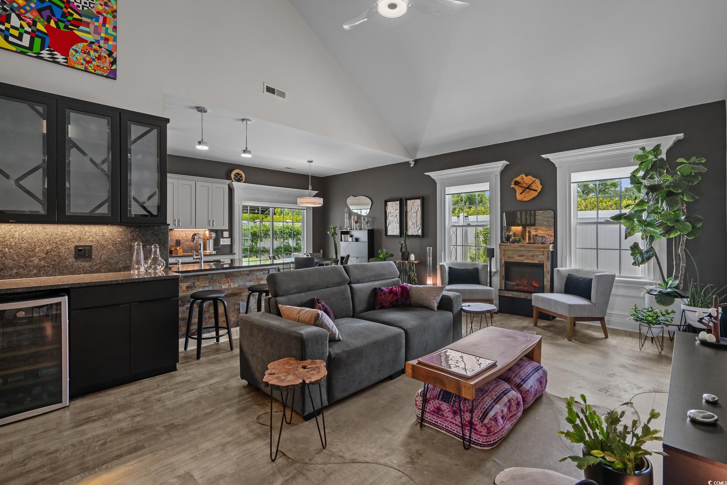 752 Hobonny Loop Longs, SC 29568 - Photo 7 of 40 Living area featuring beverage cooler, plenty of natural light, ceiling fan, a lit fireplace, and high vaulted ceiling