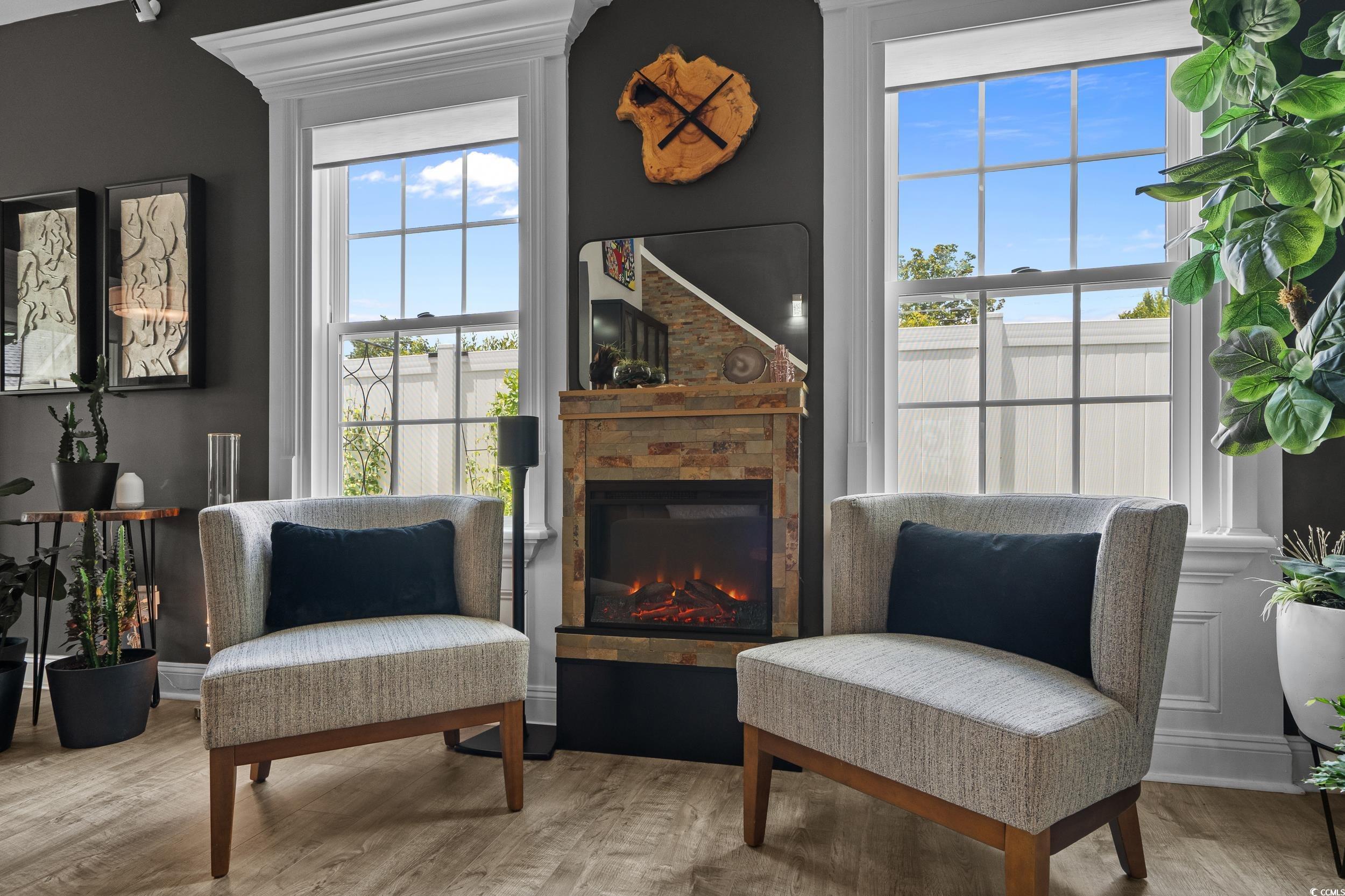 752 Hobonny Loop Longs, SC 29568 - Photo 9 of 40 Sitting room with wood finished floors and a glass covered fireplace