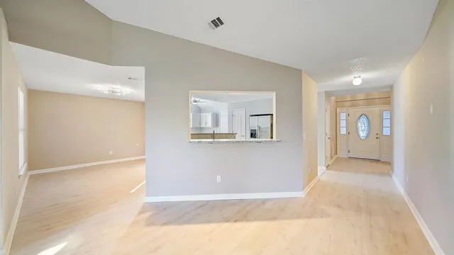 a view of a big room with closet and windows