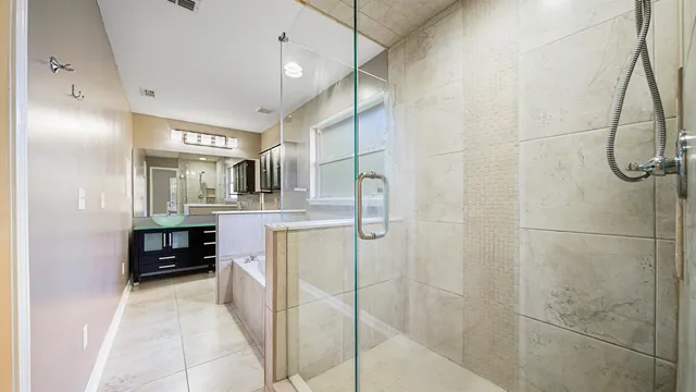 a bathroom with a double vanity sink and a shower