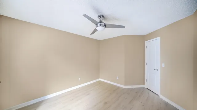 a view of a room with wooden floor
