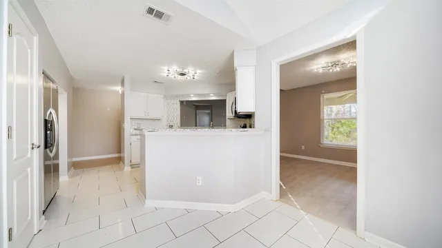 a view of a kitchen with a sink and a fireplace