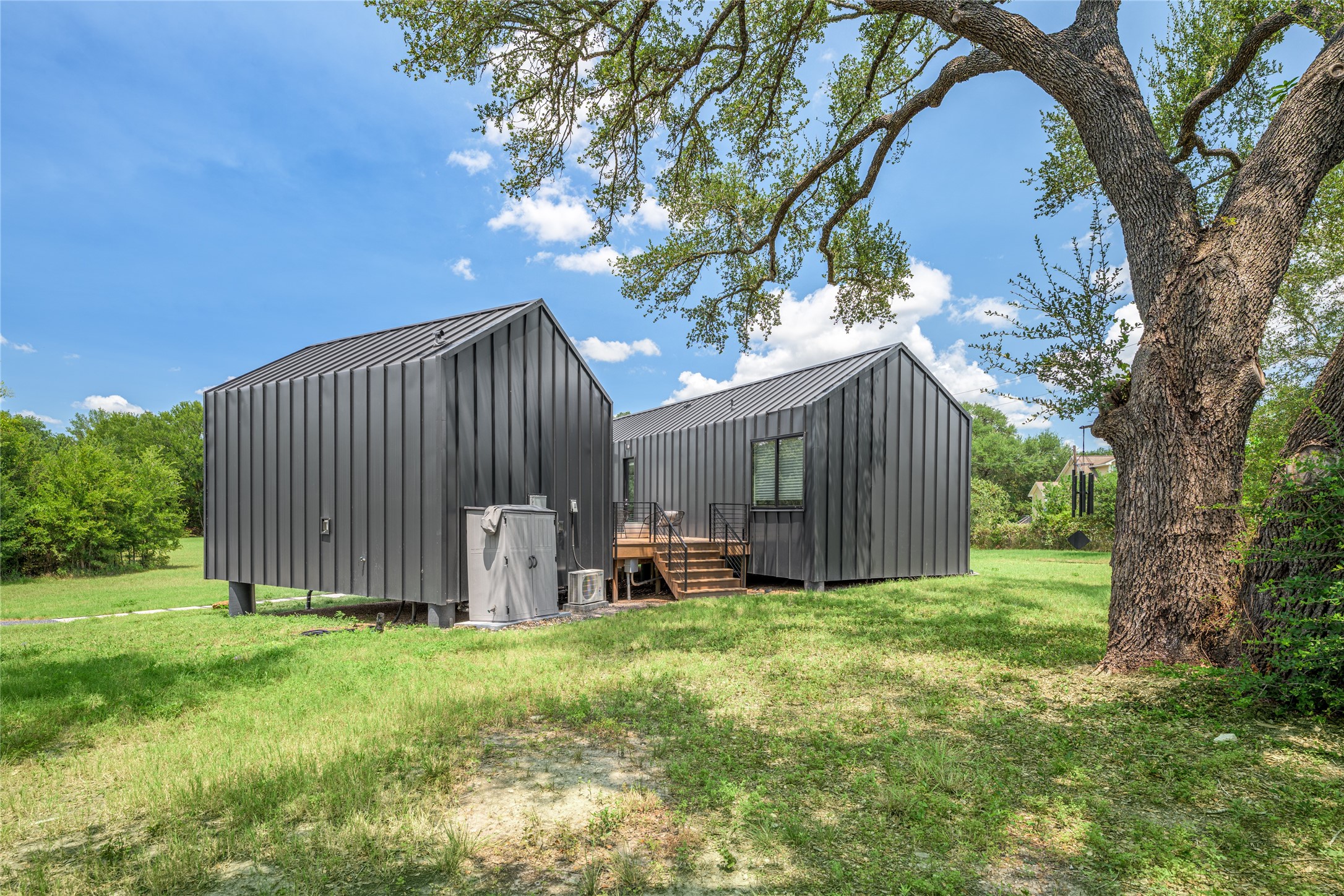 8390 Schuster Road Ledbetter, TX 78946 - Photo 21 of 27 a view of backyard with large trees and wooden fence