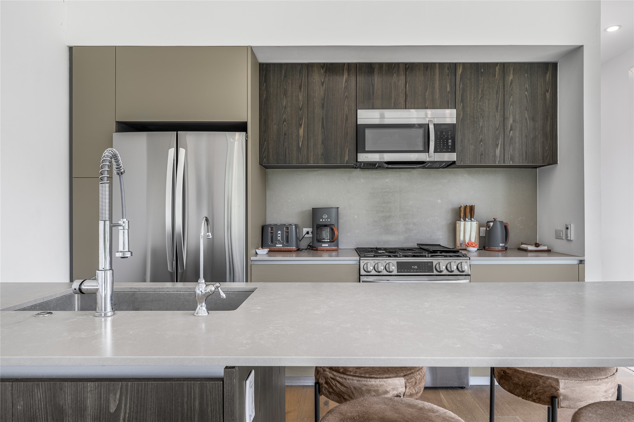 8390 Schuster Road Ledbetter, TX 78946 - Photo 6 of 27 a kitchen with stainless steel appliances granite countertop a refrigerator and stove