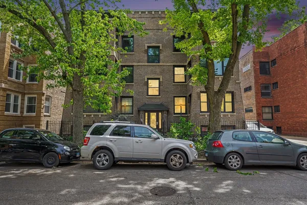 a car parked in front of a brick house