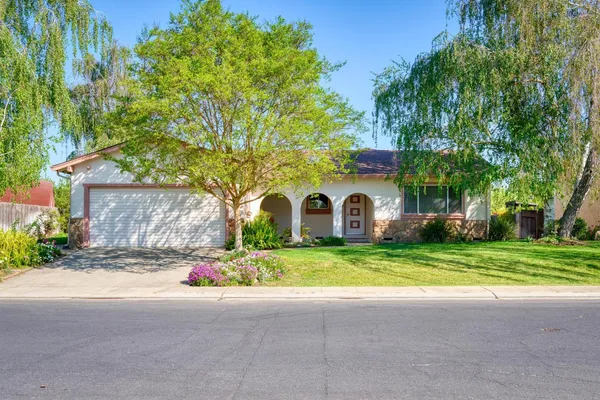 a house that has a tree in front of it