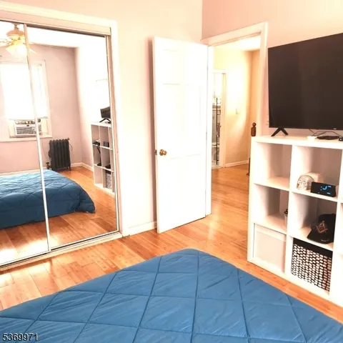 a view of a small space with wooden floor and a window