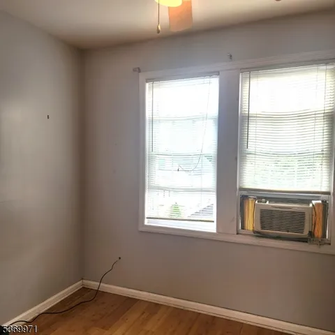 a view of a big room with closet and windows