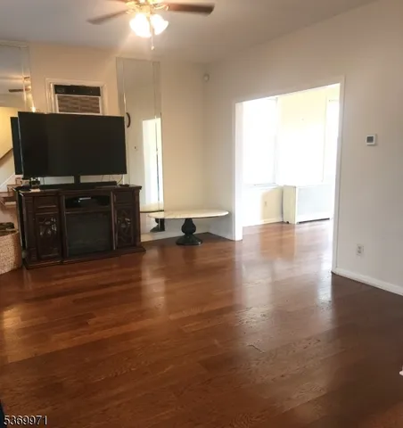 a living room with furniture and flat screen tv
