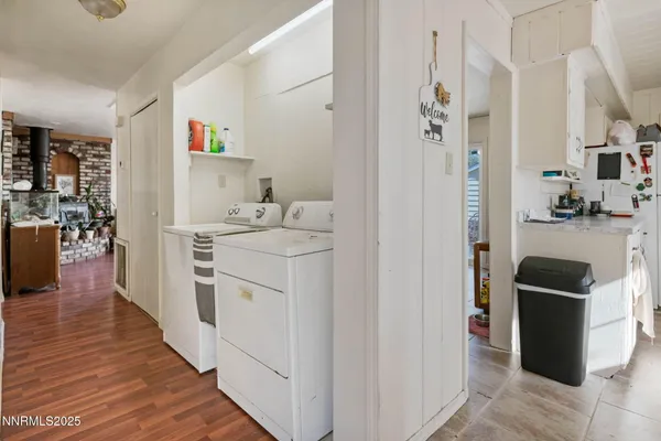 a utility room with cabinets washer and dryer