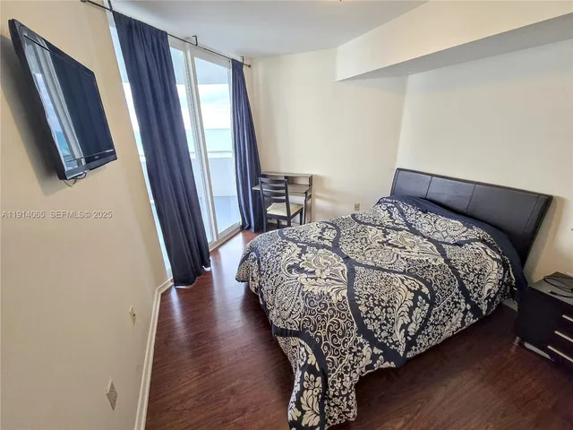 a bathroom with a sink mirror and shower