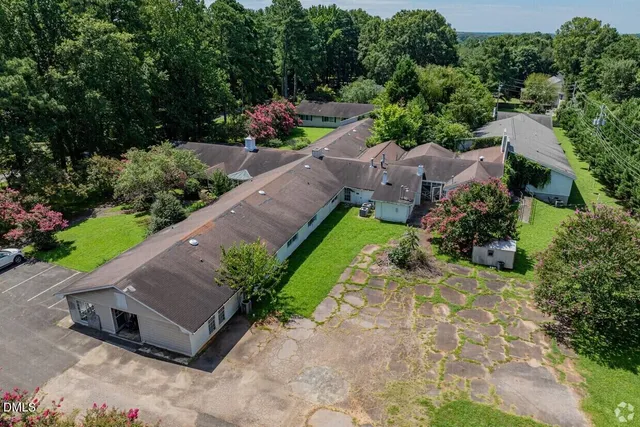 an aerial view of a residential houses with city view