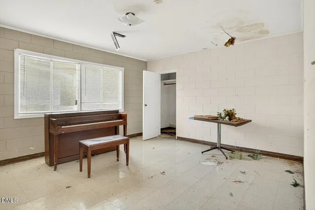 a view of a workspace with furniture and window
