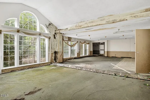 a bathroom with a tub shower and window