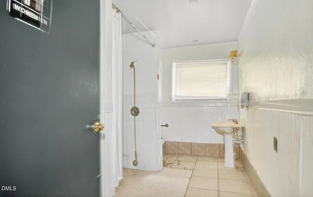 an aerial view of residential house with outdoor space and trees all around