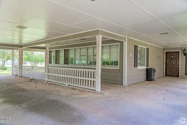 a view of a house with a yard and garage