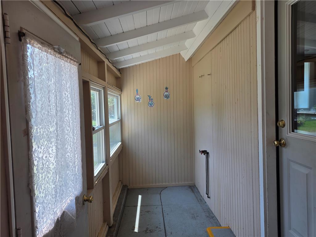 5166 Springmill Road Whitehall, PA 18052 - Photo 25 of 29 A quaint enclosed porch features bright windows and wood paneling, ideal for relaxed indoor-outdoor living.
