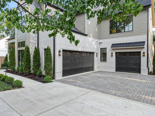 a front view of a house with yard and garage