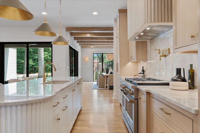 a kitchen with stainless steel appliances granite countertop a sink and a wooden floors