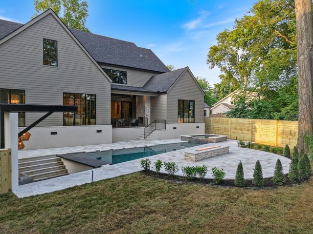 a view of swimming pool with a bench and wooden floor