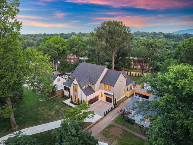 an aerial view of a house with garden space and street view