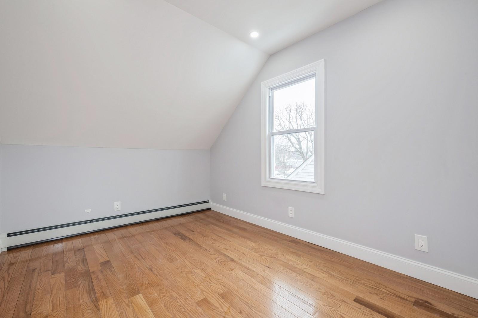 246-59 86th Road Queens, NY 11426 - Photo 26 of 44 Bonus room with a baseboard radiator, lofted ceiling, and light hardwood / wood-style floors