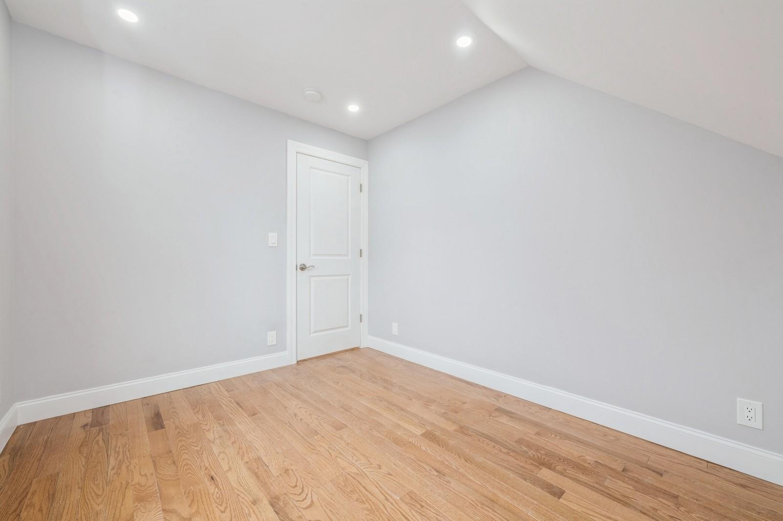 246-59 86th Road Queens, NY 11426 - Photo 28 of 44 Empty room featuring vaulted ceiling and light wood-type flooring