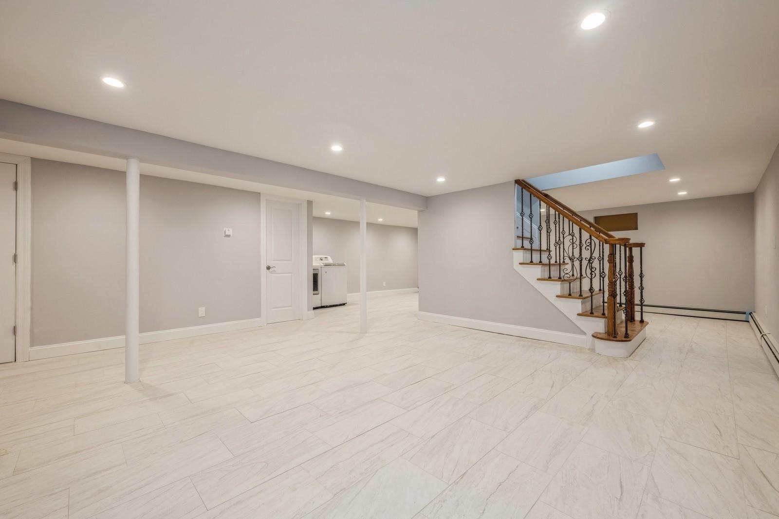 246-59 86th Road Queens, NY 11426 - Photo 38 of 44 Basement featuring washer / dryer and a baseboard heating unit