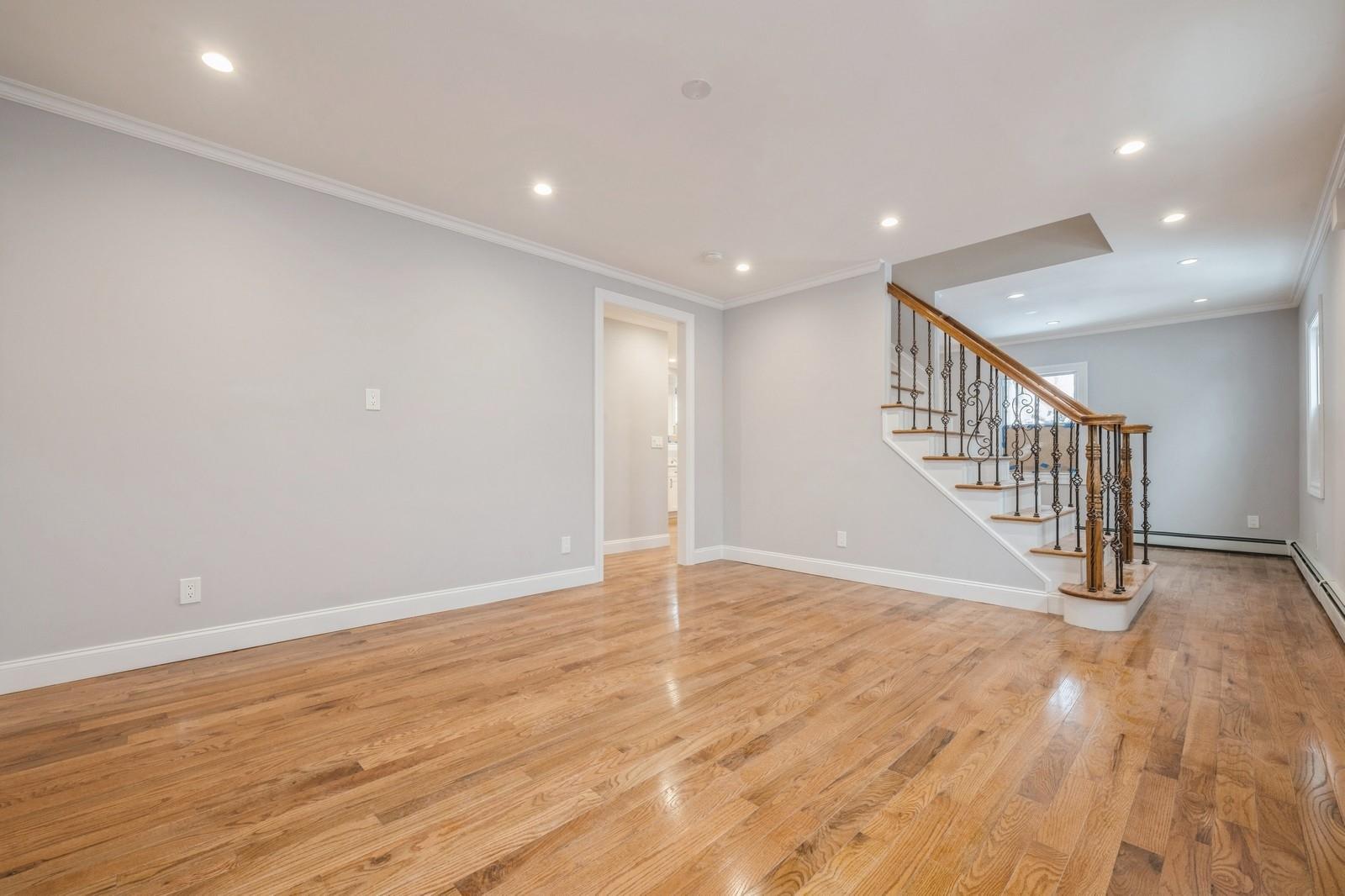 246-59 86th Road Queens, NY 11426 - Photo 5 of 44 Empty room featuring crown molding and light hardwood / wood-style floors