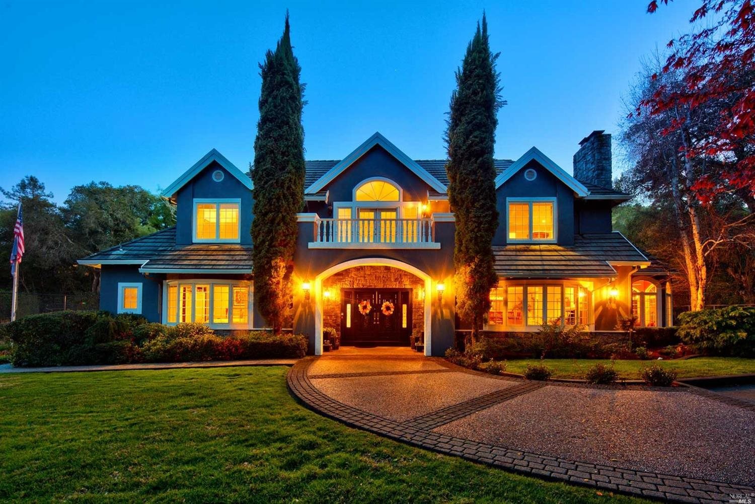 a front view of a house with a garden and patio