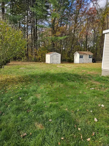 a large white kitchen with lots of counter space and wooden floor