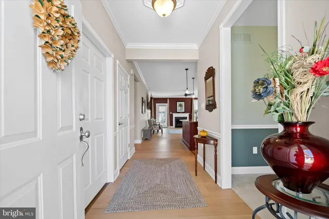 a view of a hallway to a livingroom with furniture