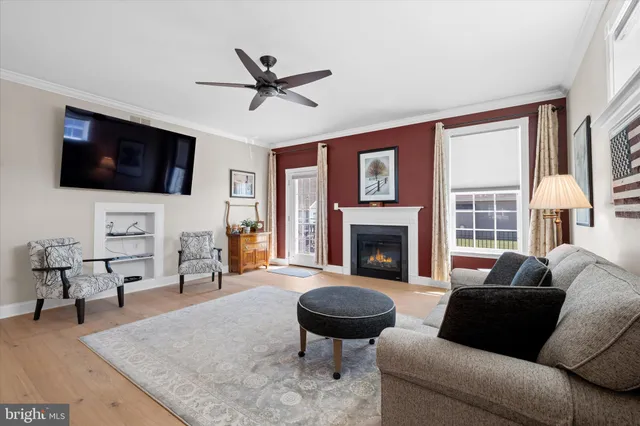 a living room with furniture fireplace and flat screen tv