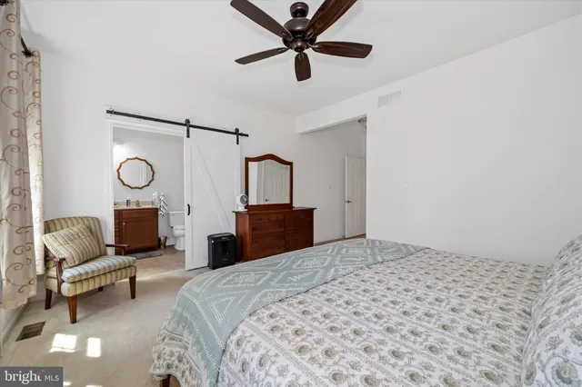 a bedroom with a bed gym equipment and a large window