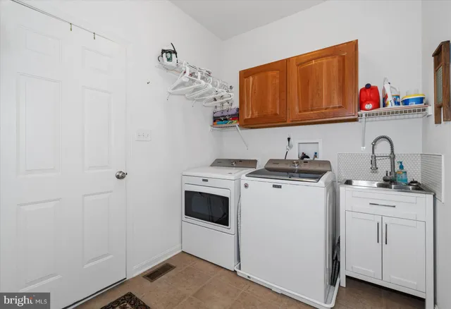 a view of storage and utility room with washer and dryer
