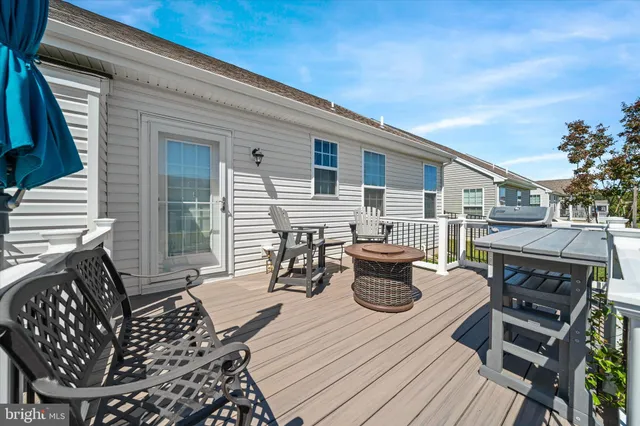 a view of a balcony with chairs and wooden floor