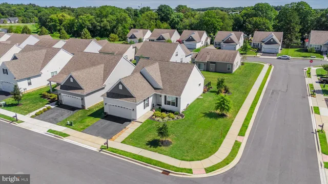 an aerial view of a house with garden space and street view