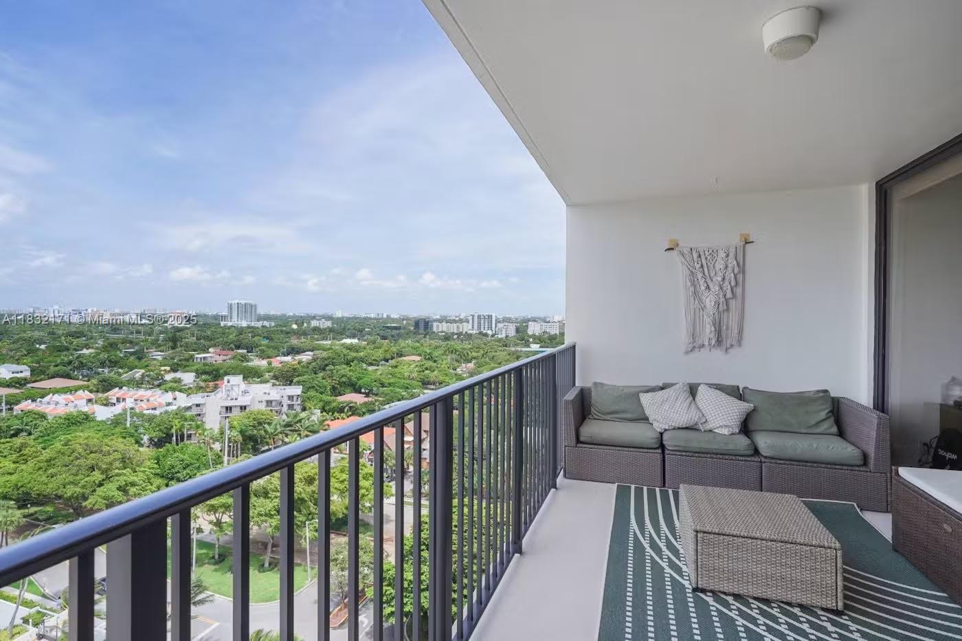 1901 Brickell Avenue, Unit B1706 Miami, FL 33129 - Photo 14 of 15 a balcony with wooden floor and city view
